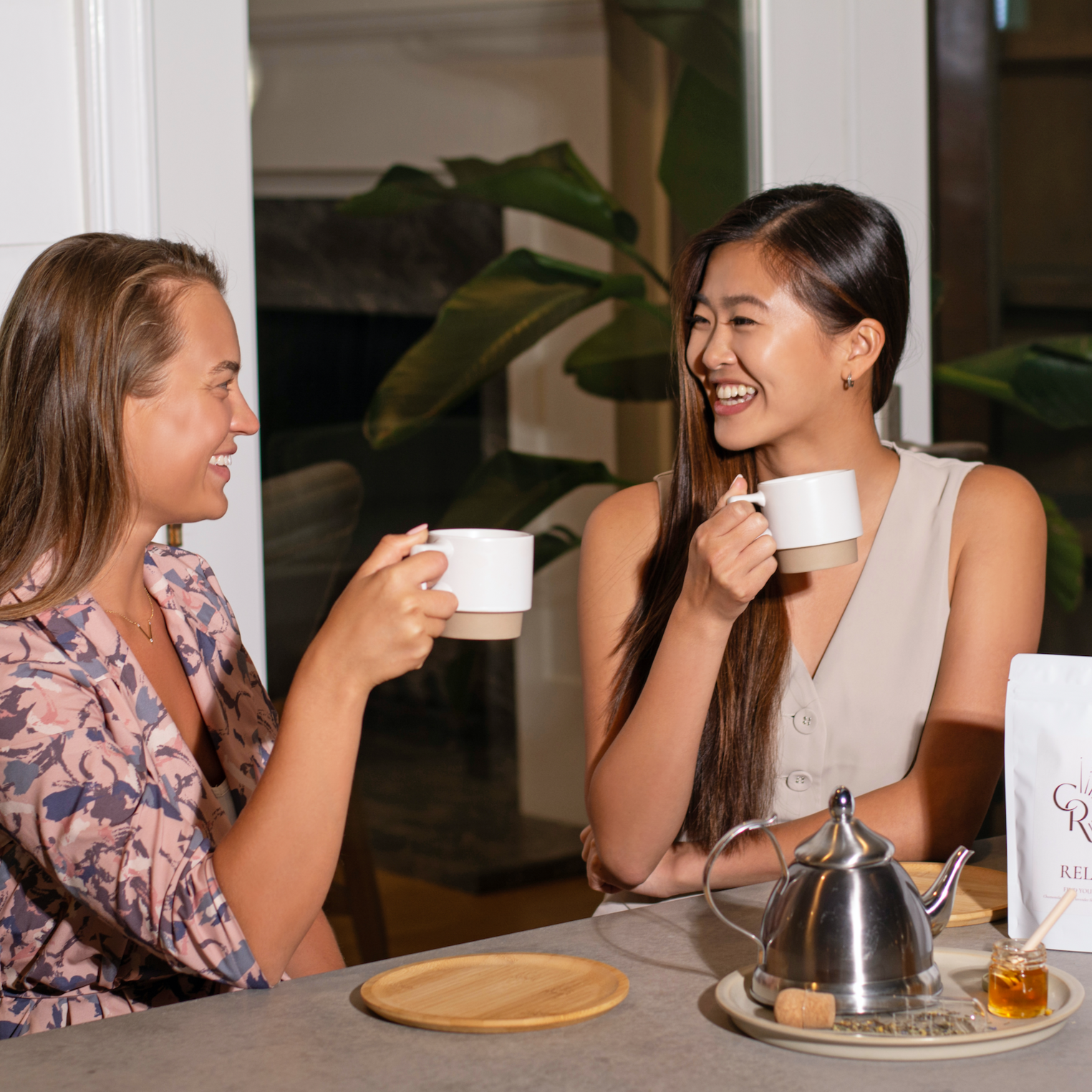 Women enjoying Resilient Loose Leaf Tea during productive work session
